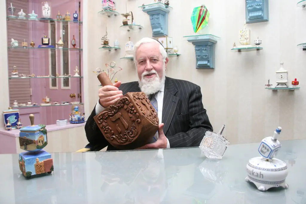 Rabbi Safran with giant carved dreidel