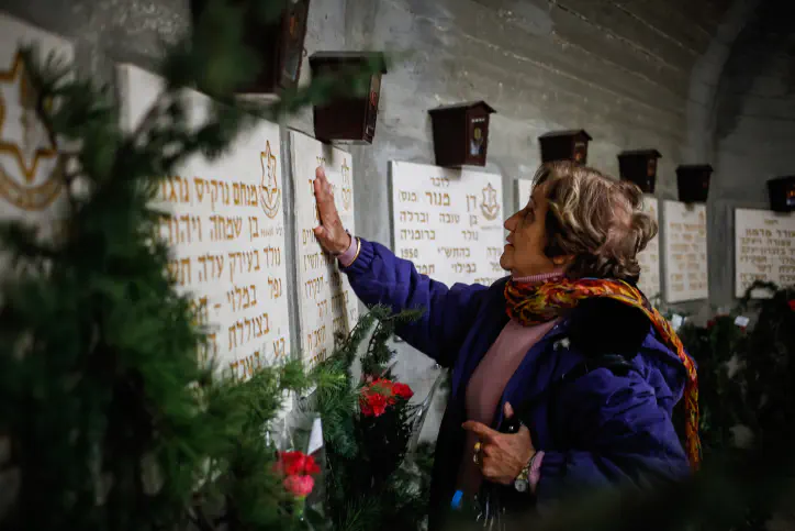 A woman visits the gravestones for soldiers killed in the Dakar Submarine incident