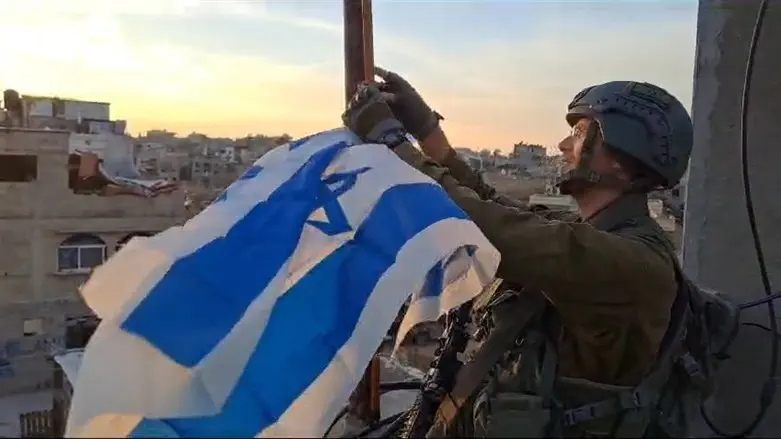 Courtesy Reservist raises flag he lowered leaving Gush Katif