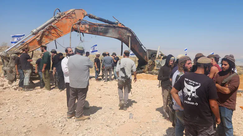 Excavator used by contractor killed in Gaza placed next to grave