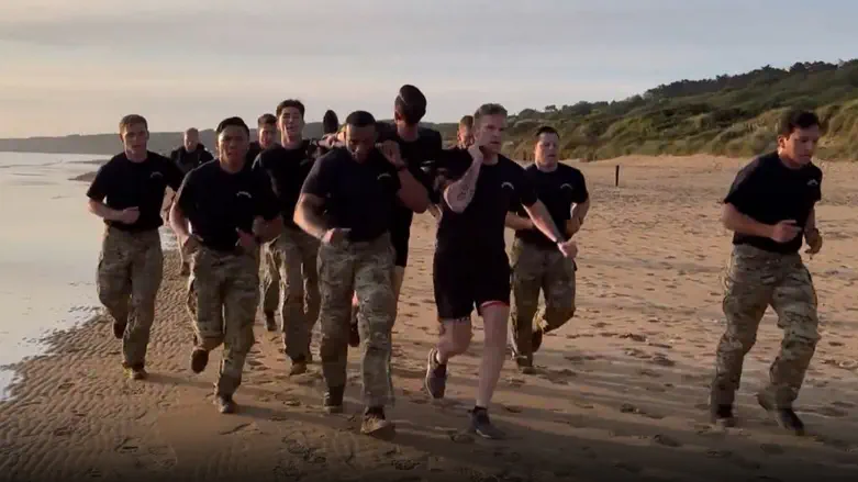 Defense Sec. Hegseth leads morning workout on Omaha Beach