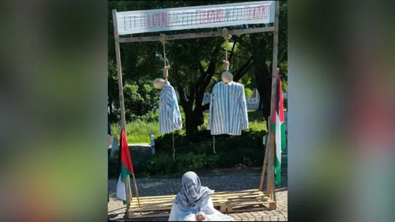 Protestors hang effigies in concentration camp uniforms