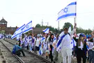 Captivity and Holocaust survivors march together in Aushwitz