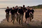 Defense Sec. Hegseth leads morning workout on Omaha Beach