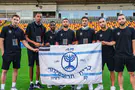 Beitar players take field in Riga holding piece of history