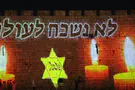 Yellow star, 'We will never forget' projected on Old City walls