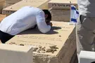 Minister Waserlauf broke down in tears at his rabbi's grave