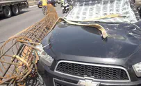 Giant metal cylinder falls on car traveling on Ayalon Highway