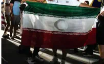 A mullah’s flag with a hole in is the symbol of the revolution