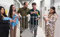 Wounded soldier lights Hanukkah candle with Dr who saved his life