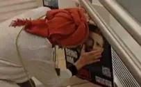 Hostage's mother stops to hug son's picture in airport