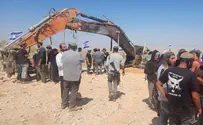 Excavator used by contractor killed in Gaza placed next to grave
