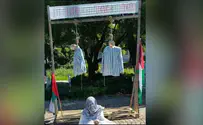 Protestors hang effigies in concentration camp uniforms