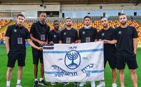 Beitar players take field in Riga holding piece of history