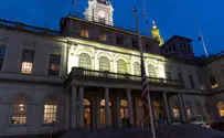 Courtesy of NYC Council New York City Hall lit yellow, flags flown at half-staff