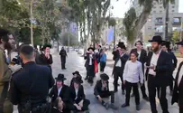 Protesters swarm haredi soldier, shout: "Traitor"