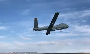 UAV operator and ground troops work to eliminate terrorist