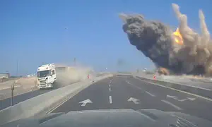 Missile falls meters from moving vehicle