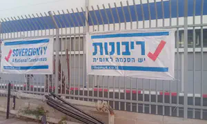 Signs calling for sovereignty hung on fence of US base