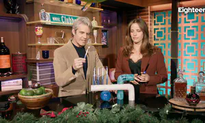 Noa Tishby lights Hanukkah candles with Andy Cohen