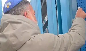 UNRWA worker murdered his son, now he affixed a mezuzah on its HQ