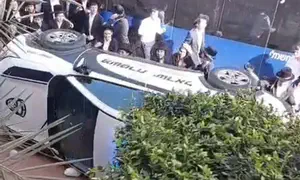 Minor arrested on suspicion of overturning police car