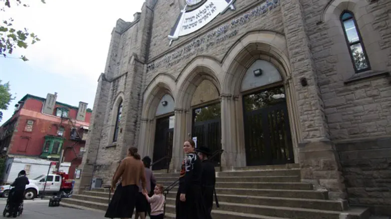Hasidic women walk past a yeshiva in the Williamsburg section of Brooklyn