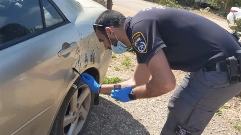 Police inspect vandalized car