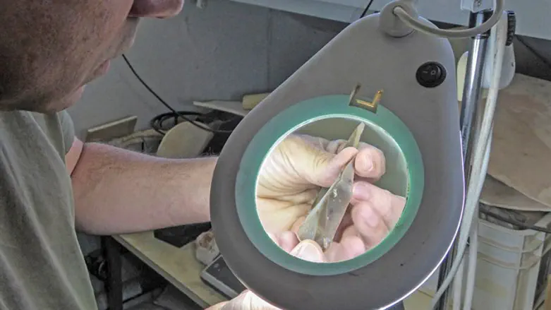 Prehistorian Dr. Omry Barzilai inspecting a flint tool from Boker Tachtit