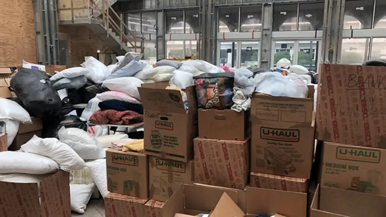 A social hall under construction in The Shul is piled high with donations
