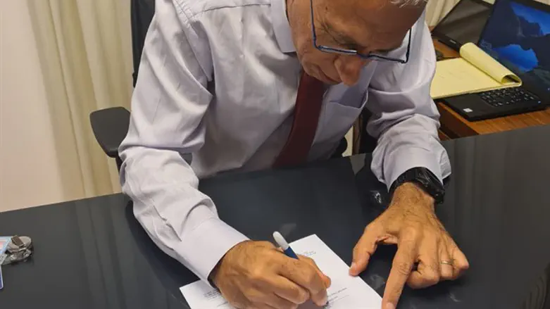 Professor Nachman Ash signs the order