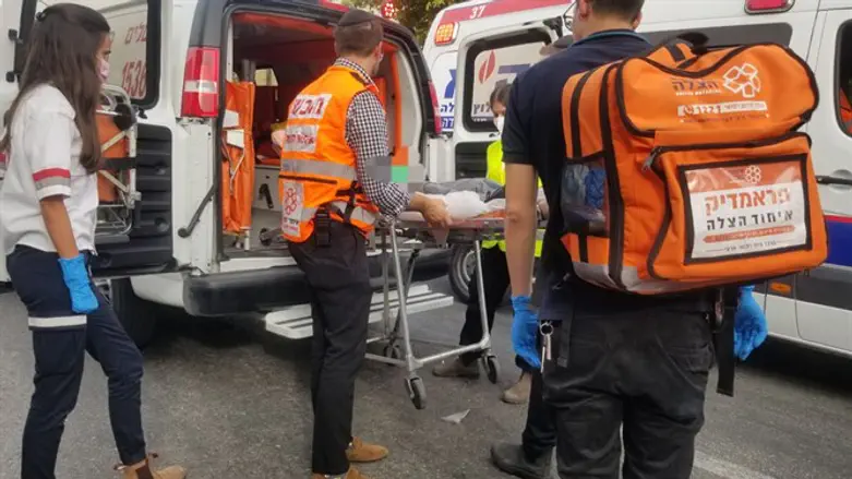 UH volunteers load patient into ambulance