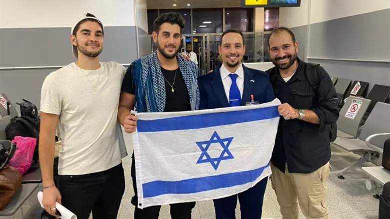 The three who were freed, with the Israeli representative