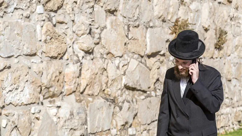 A haredu man with a cell phone