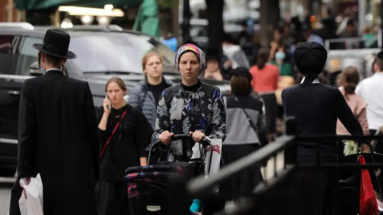 People walk through the Brooklyn neighborhood of Williamsburg in New York City, 