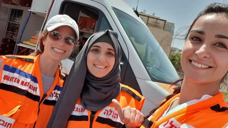 Three women EMT volunteers of United Hatzalah after finishing an ambulance shift