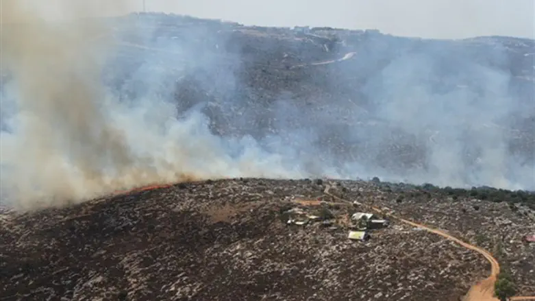 Fire sweeps towards a farm in West Tapuah