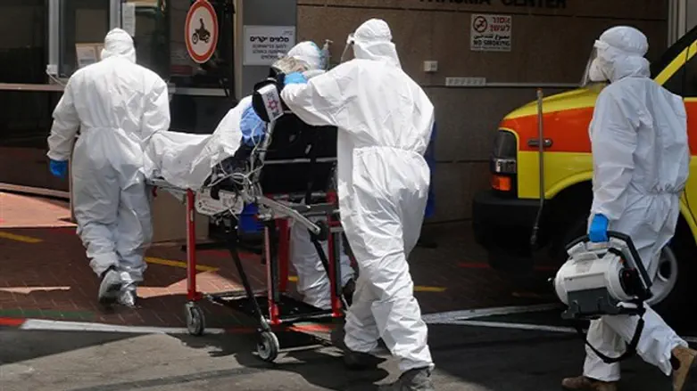  Medical staff wheel a patient into the COVID unit