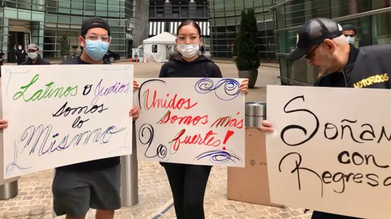 Protestors hold up signs in front of the Spanish Consulate in New York City