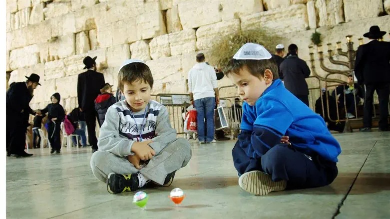 Playing with dreidels at the Western Wall, Hannukah