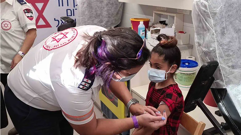 MDA personnel vaccinating children at school