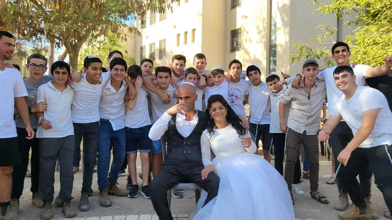 Students of the Belevav Shalem yeshiva, with the bride and groom