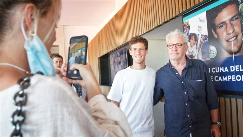 Diego Schwartzman and his father Ricardo pose for photos during the inauguration