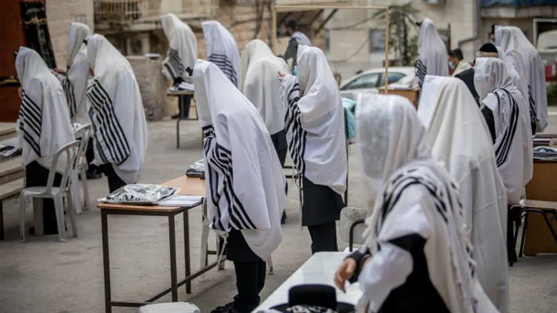 Worshippers pray outside during coronavirus crisis