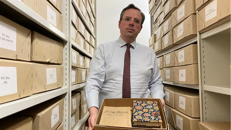 Toby Simpson shows a reporter documents in the Wiener Holocaust Library in centr