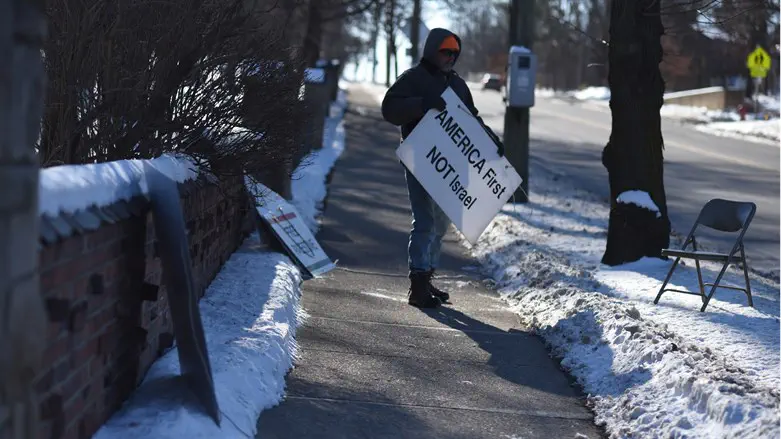 A protester stands outside Beth Israel Congregation in Ann Arbor, Michigan