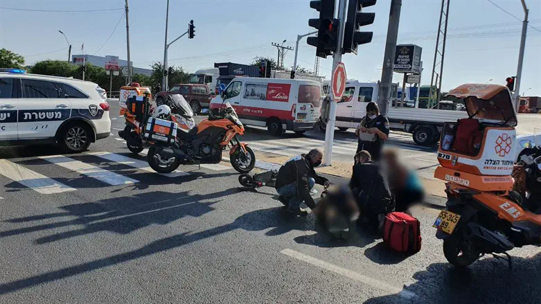 United Hatzalah volunteers treating a seriously injured man after a scooter acci