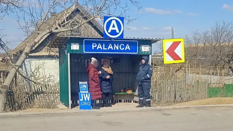 Missionaries stand on the Moldova side of the border
