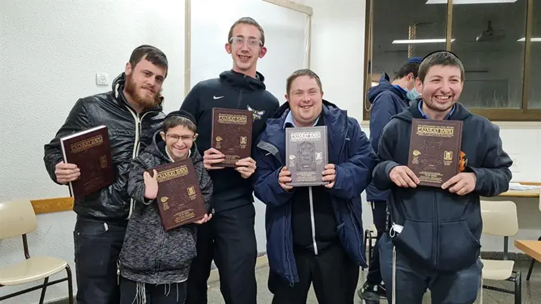 Students at Yeshivat Darkaynu receive gemaras in honor of completing a tractate.