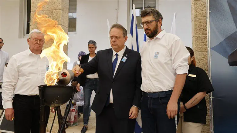 German Rozhkov (L) & Edward German (R) light a memorial torch together with Yaakov Hagoel